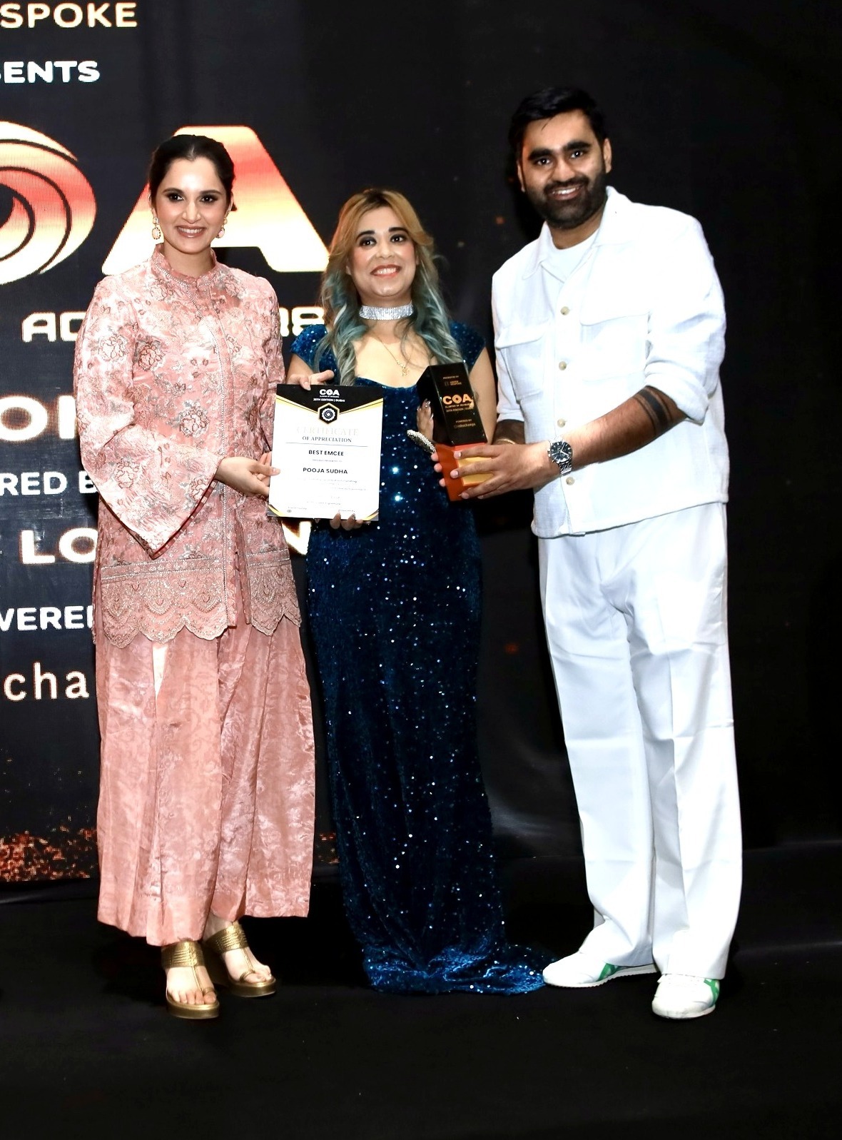 Pooja Sudha receiving the Best EmCee certificate and trophy from Sania Mirza at the Club of Achievers 25th edition awards