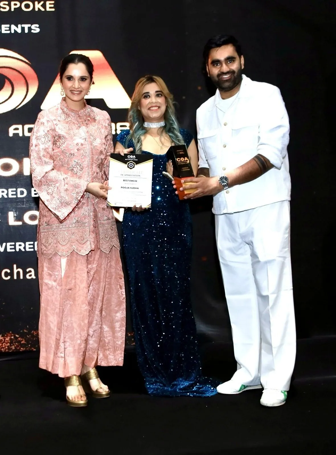 Pooja Sudha receiving the Best EmCee certificate and trophy from Sania Mirza at the Club of Achievers 25th edition awards