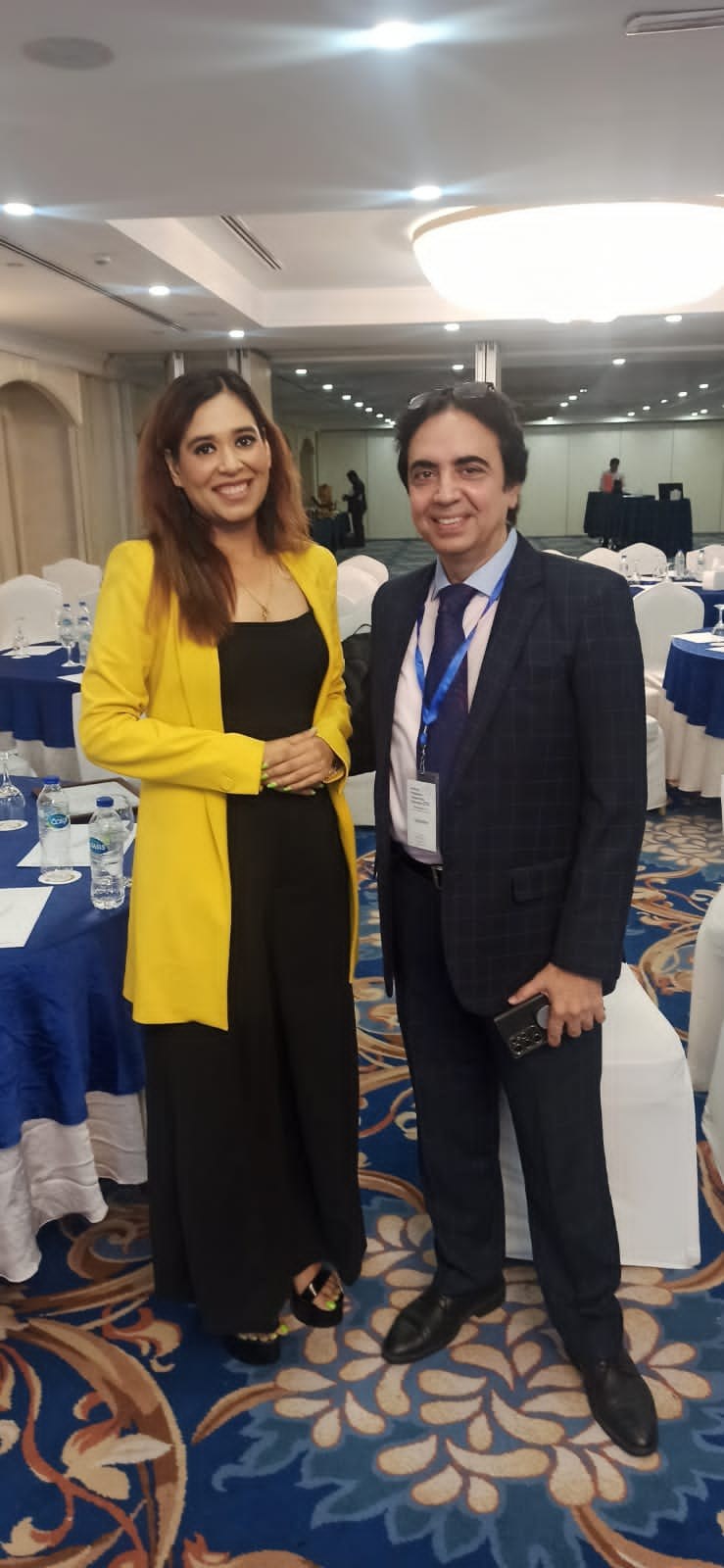 Pooja Sudha at a corporate conference in a yellow blazer
