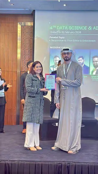 Pooja Sudha receiving recognition at a Data Science and AI summit
