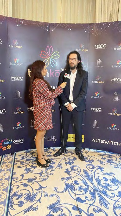 Pooja Sudha interviewing a guest on the media wall at an industry event