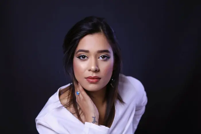 Pooja Sudha studio headshot in a white shirt