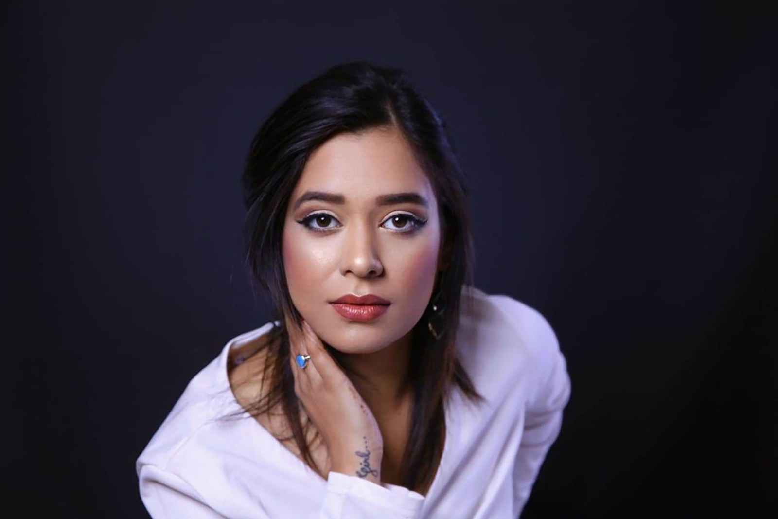 Pooja Sudha studio headshot in a white shirt