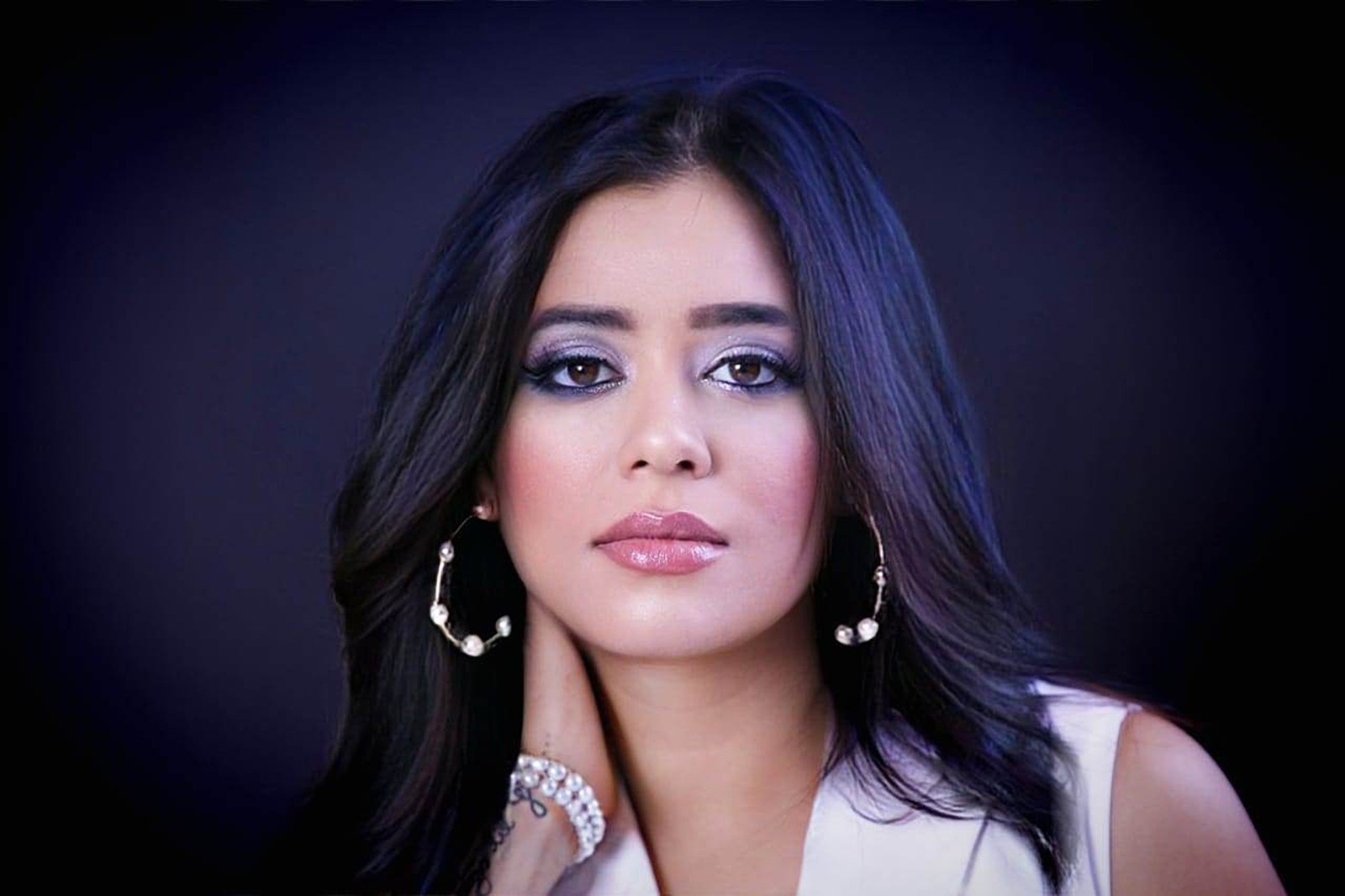 Pooja Sudha studio portrait wearing pearl earrings