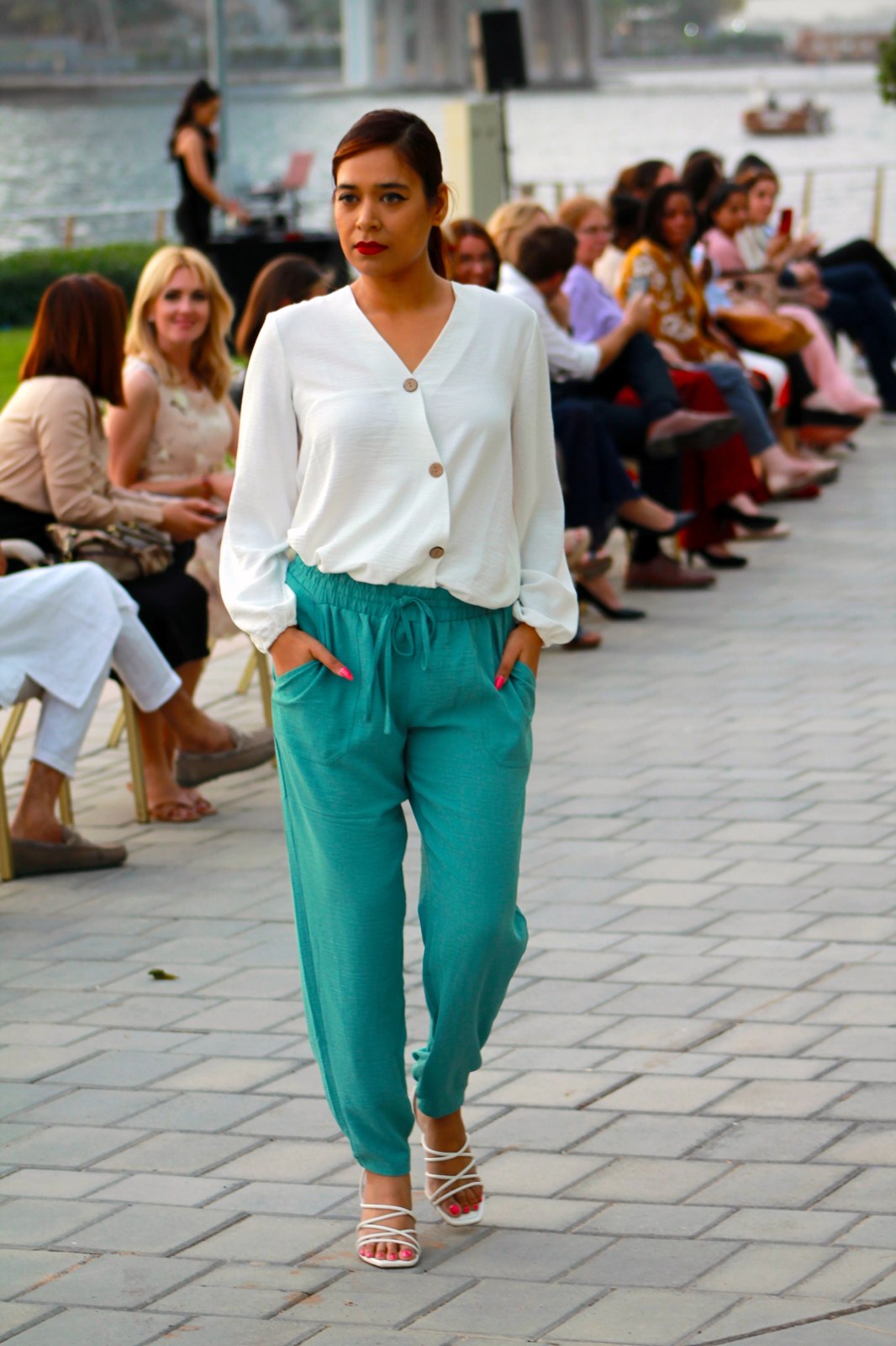 Pooja Sudha walking the runway at a waterside fashion show